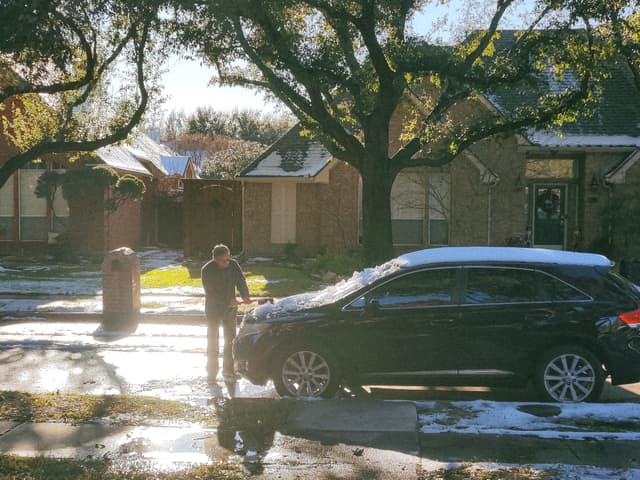 Photo of a guy cleaning their car